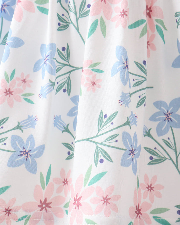 Floral patterned fabric with pink, blue, and green flowers on a white background