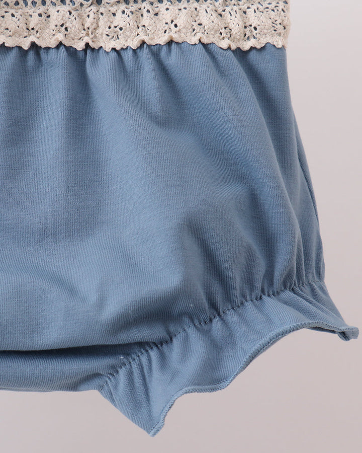 Blue fabric with lace trim on a plain background