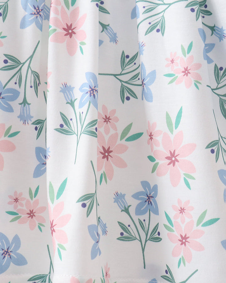 Floral patterned fabric with pink, blue, and green flowers on a white background