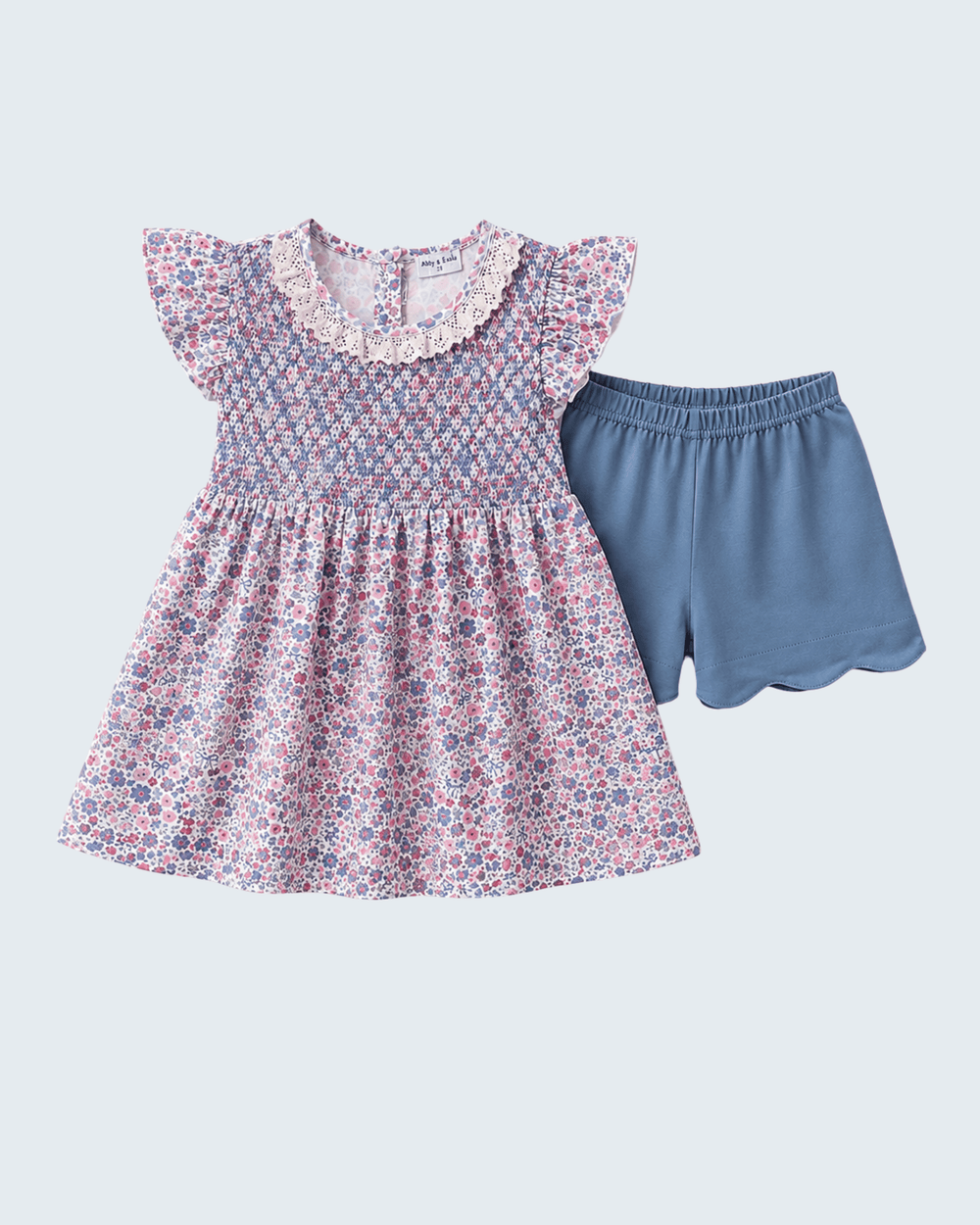 Floral smocked dress with flutter sleeves paired with blue scalloped shorts set