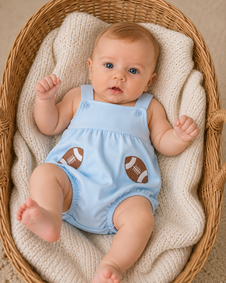 Light blue football applique bubble romper on baby, sleeveless with snap closures