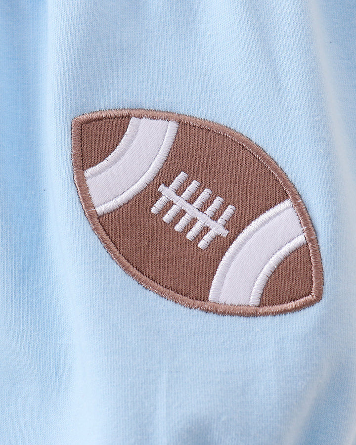 Light blue baby romper with brown football applique and white laces on chest