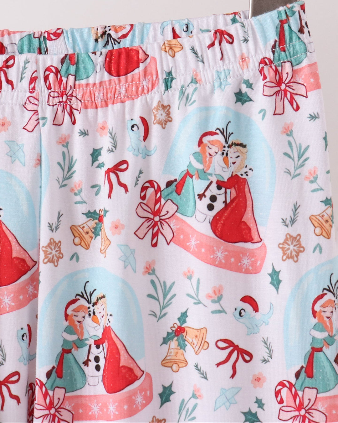 Light blue pajama pants close-up with elastic waistband and allover skater girl pattern