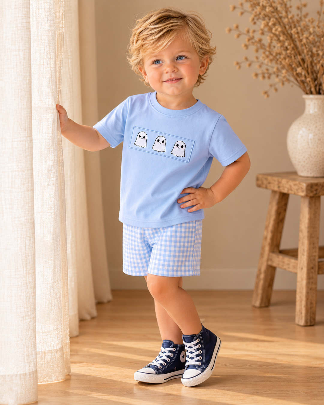 Blue T-shirt with ghost print and gingham shorts worn by child