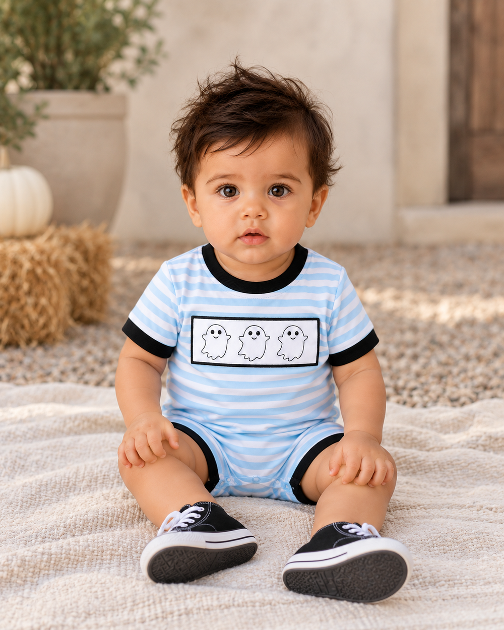 Light blue striped ghost romper on baby with black-trimmed neckline
