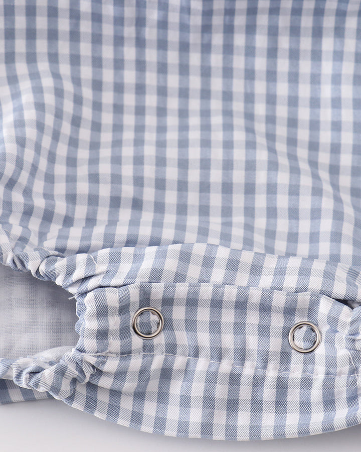 Blue gingham bubble romper back with snap buttons at waist and ruching at leg