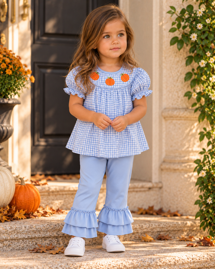 Girl in blue gingham pumpkin ruffle top and light blue ruffle pants