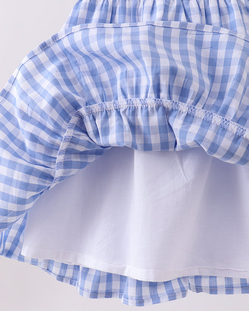 Blue and white checkered dress on a light gray background
