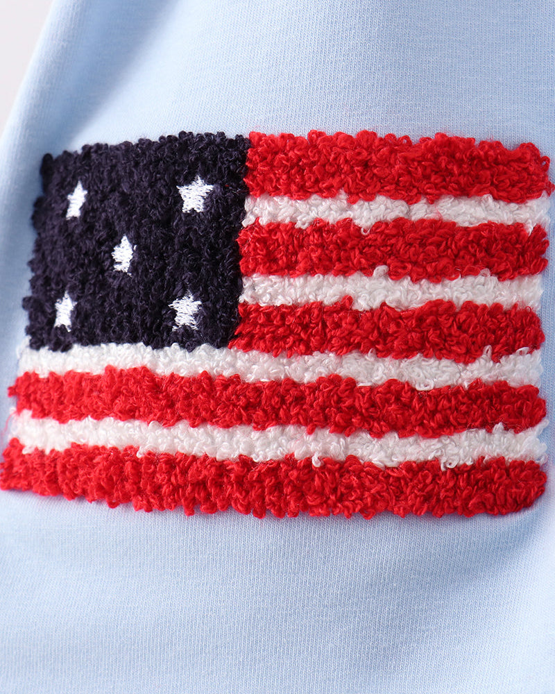Blue fabric with the American flag in French knot