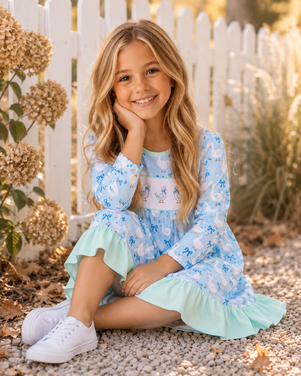 Light blue goose-print dress with mint ruffle hem, worn by a child