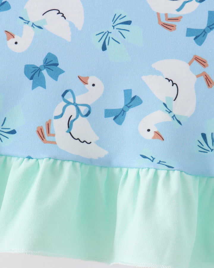 Light blue dress with gathered mint ruffle hem and repeated goose print