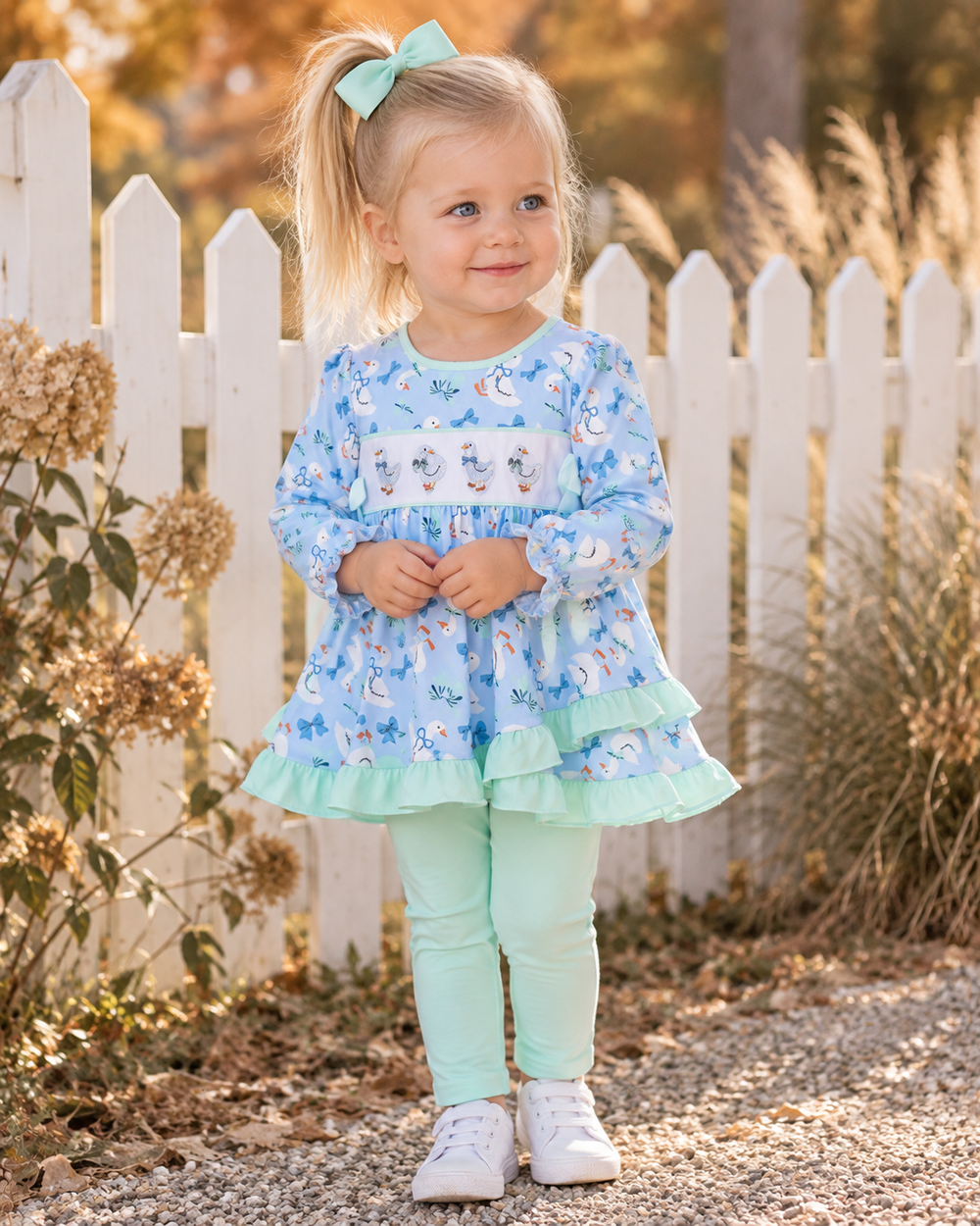 Kids' light blue printed ruffle top and mint pants set worn outdoors