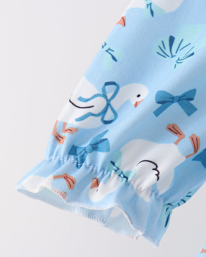 Light blue ruffle sleeve top with printed animals and elastic cuff