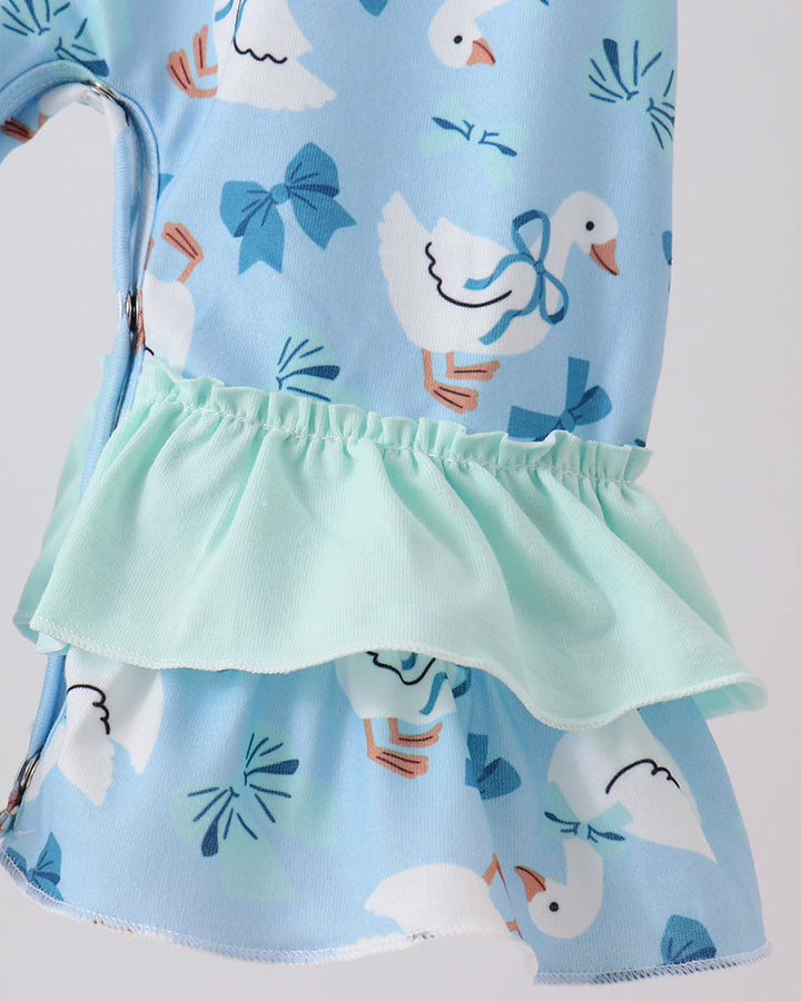 Light blue romper with mint ruffled waist and tiered skirt, goose pattern.