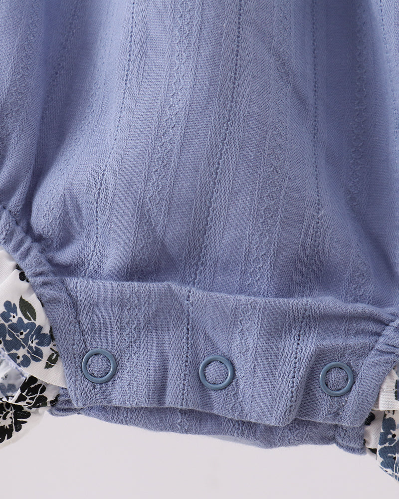 Light blue bubble romper with snap-button leg opening and gathered waist