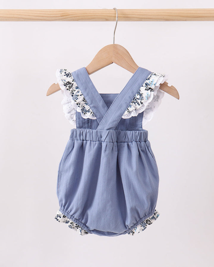 Light blue bubble romper with V-neck straps and ruffled leg openings