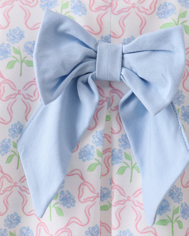 Light blue bow tie on a floral patterned background
