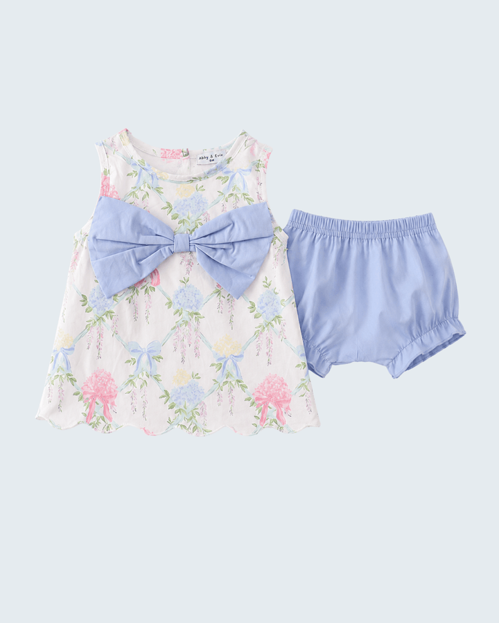 Floral dress with a large bow and matching bloomers on a light blue background