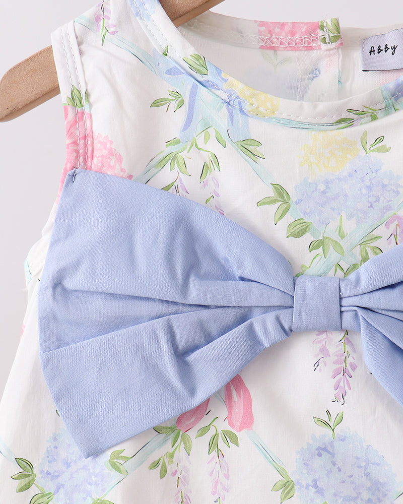 Floral dress with a large blue bow on a hanger
