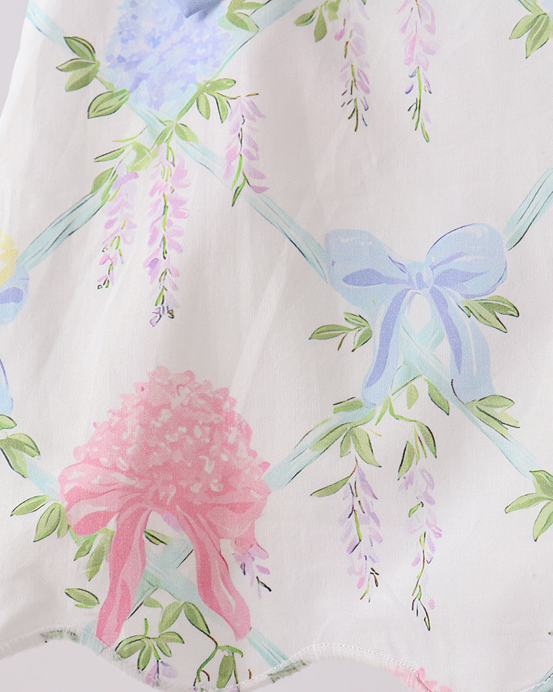Fabric with floral and bow pattern on a white background