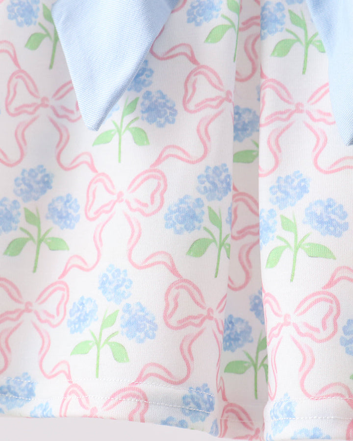 Close-up of a fabric with floral and bow pattern