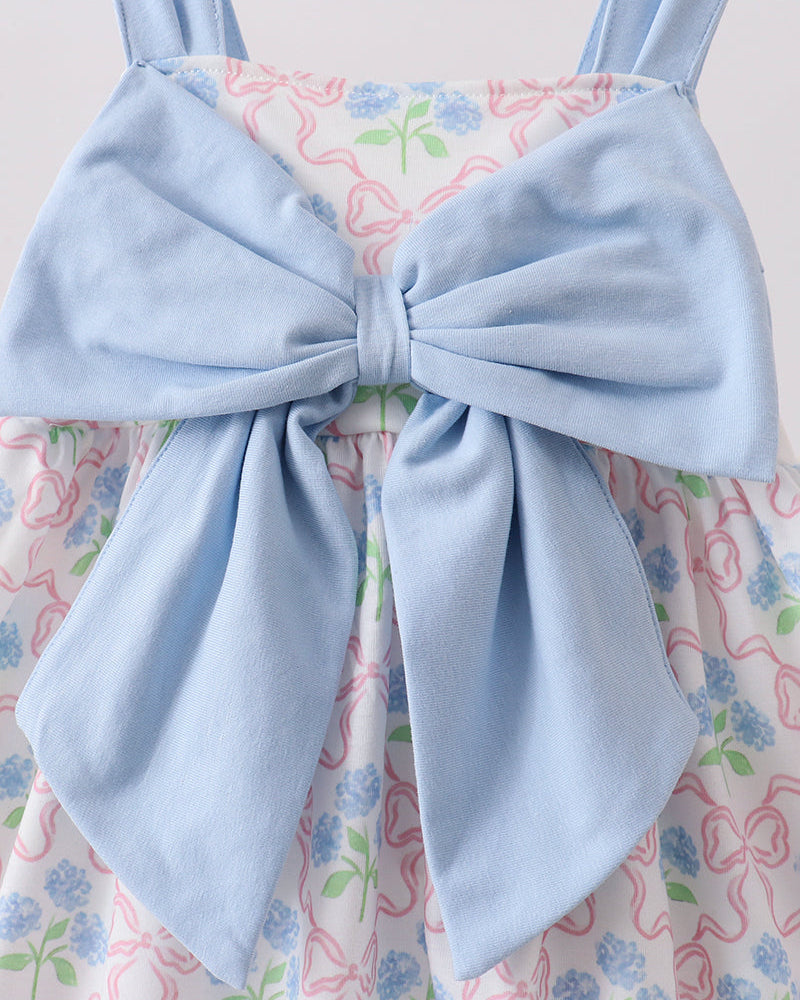 Light blue dress with a large bow on a floral background