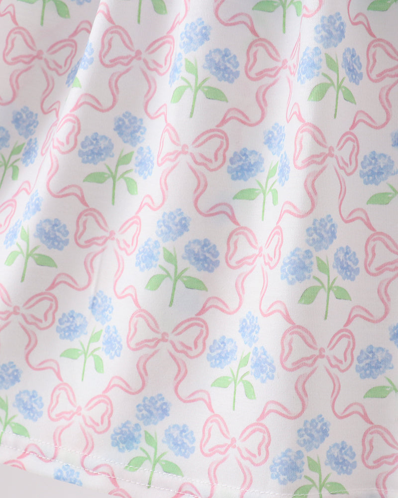 Fabric with pink bows and blue flowers pattern on a white background