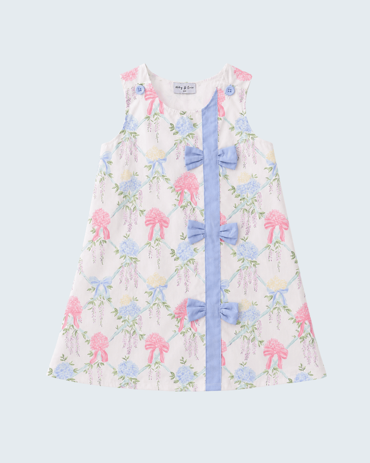 Floral dress with blue ribbon on a light gray background