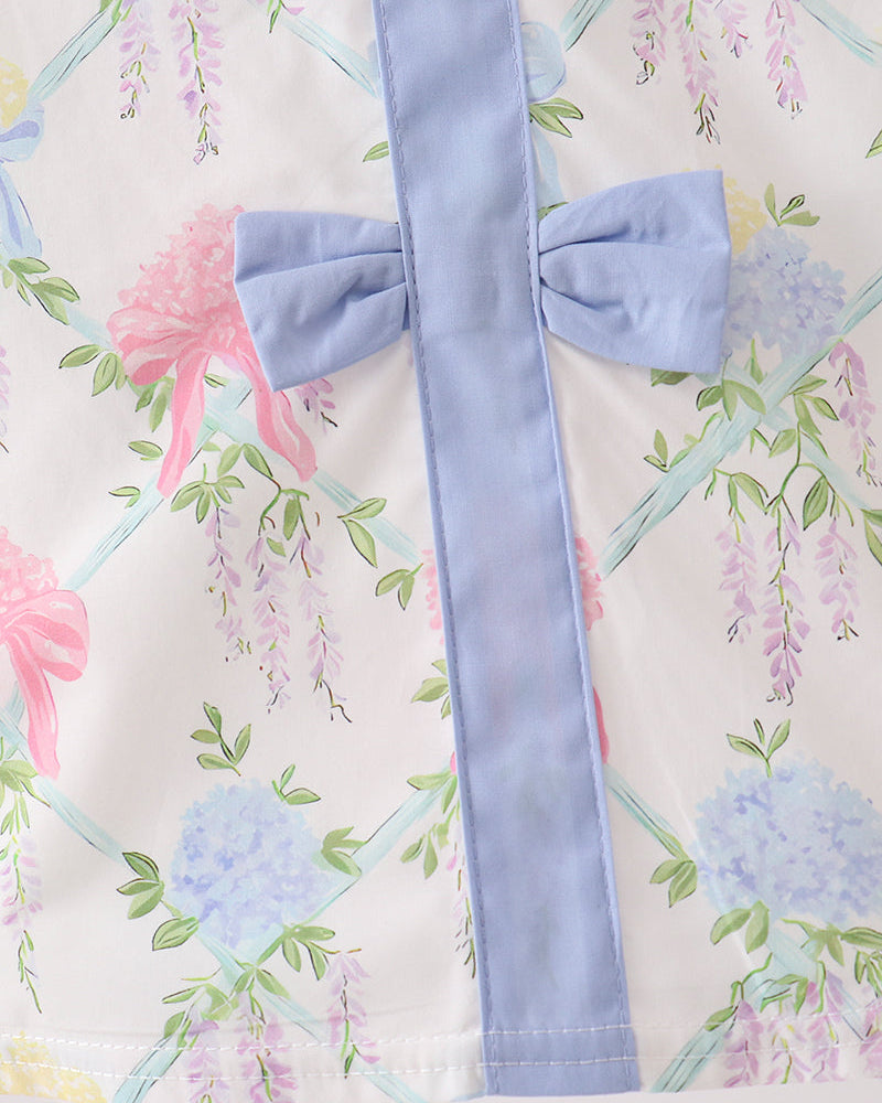 Light blue ribbon with a bow on a floral background