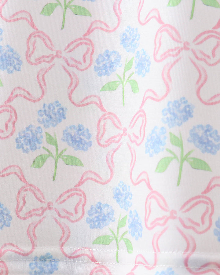 Fabric with pink bows and blue flowers on a white background