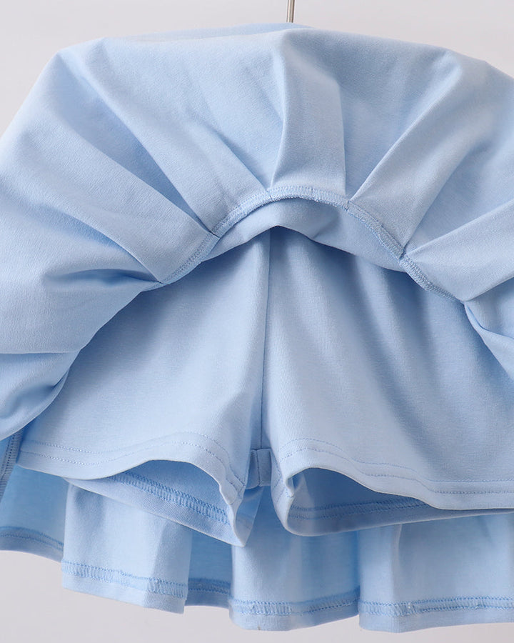 Light blue ruffled skorts on a white background