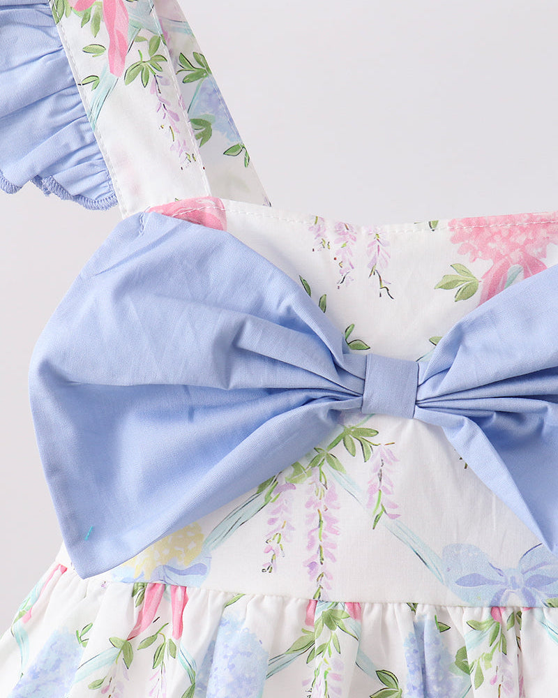 Floral dress with a large blue bow on a light background