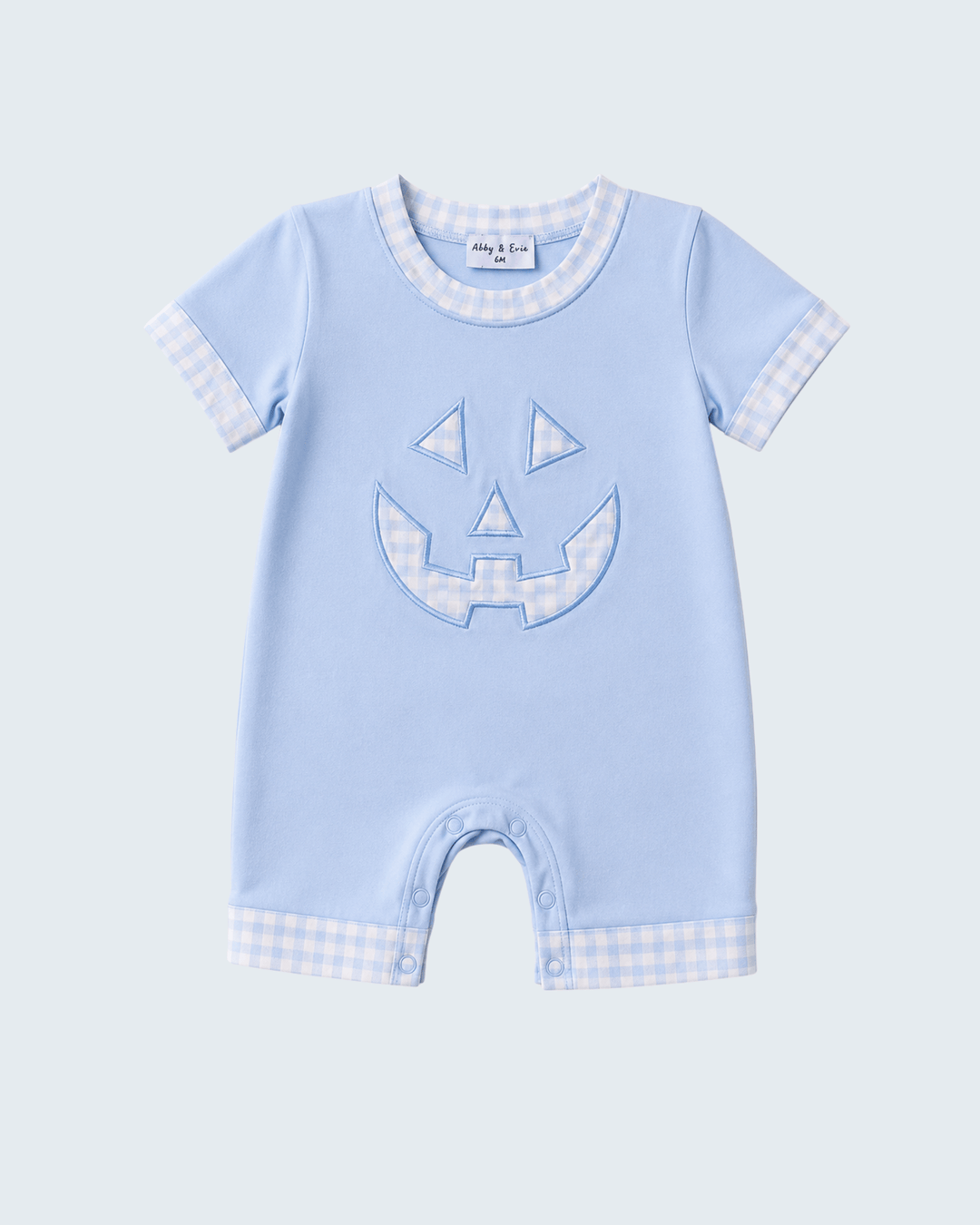 Light blue short-sleeve romper with jack-o-lantern face applique and check trim