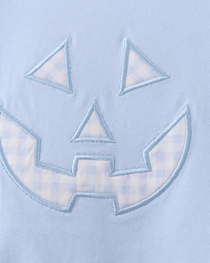 Light blue romper with stitched jack-o-lantern face applique detail
