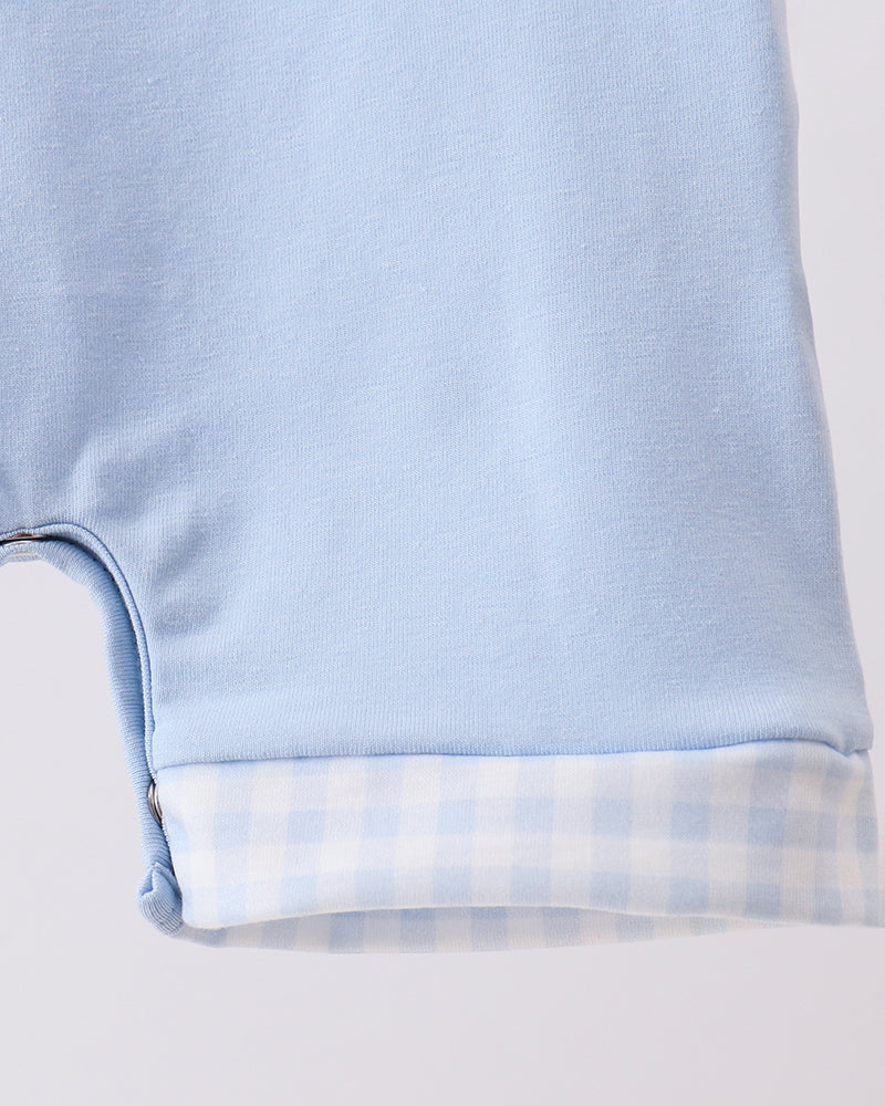 Light blue romper with checkered trim at leg cuffs
