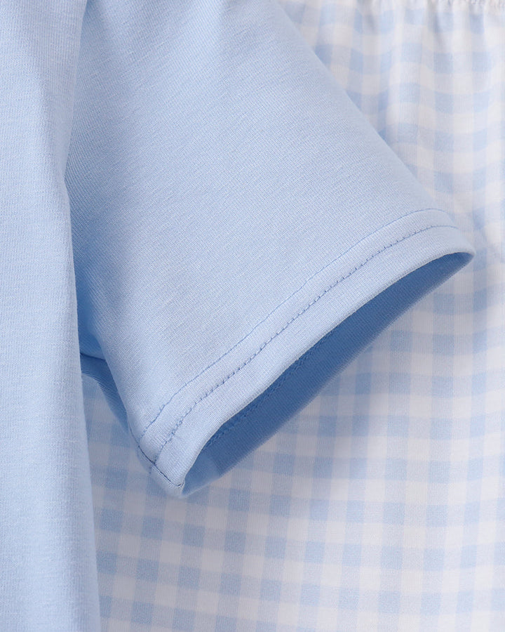 Light blue T-shirt sleeve with stitched hem seam and collar edge