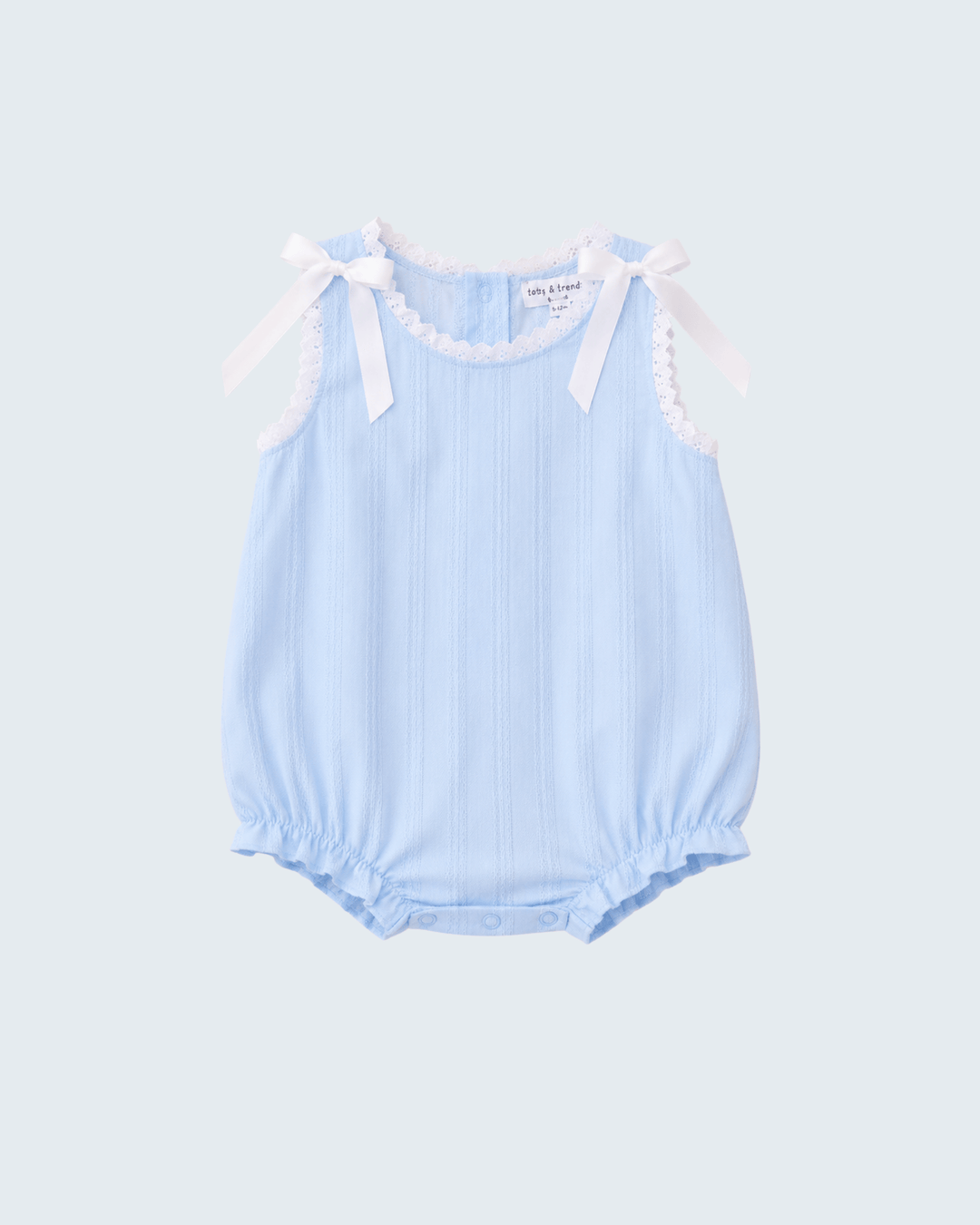A light blue sleeveless baby romper with vertical ruffles, scalloped trim, and white ribbon bows at the shoulders, shown against a light gray background.