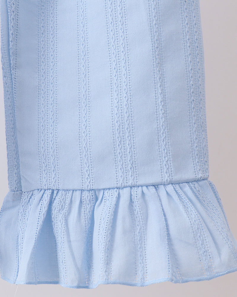 Close-up of a light blue eyelet fabric garment, showing vertical embroidered stripes and a ruffled hem against a plain light background.
