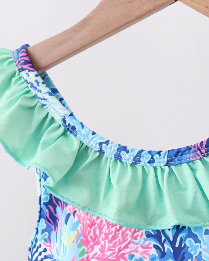 Colorful ruffled swimsuit with a patterned design on a white background