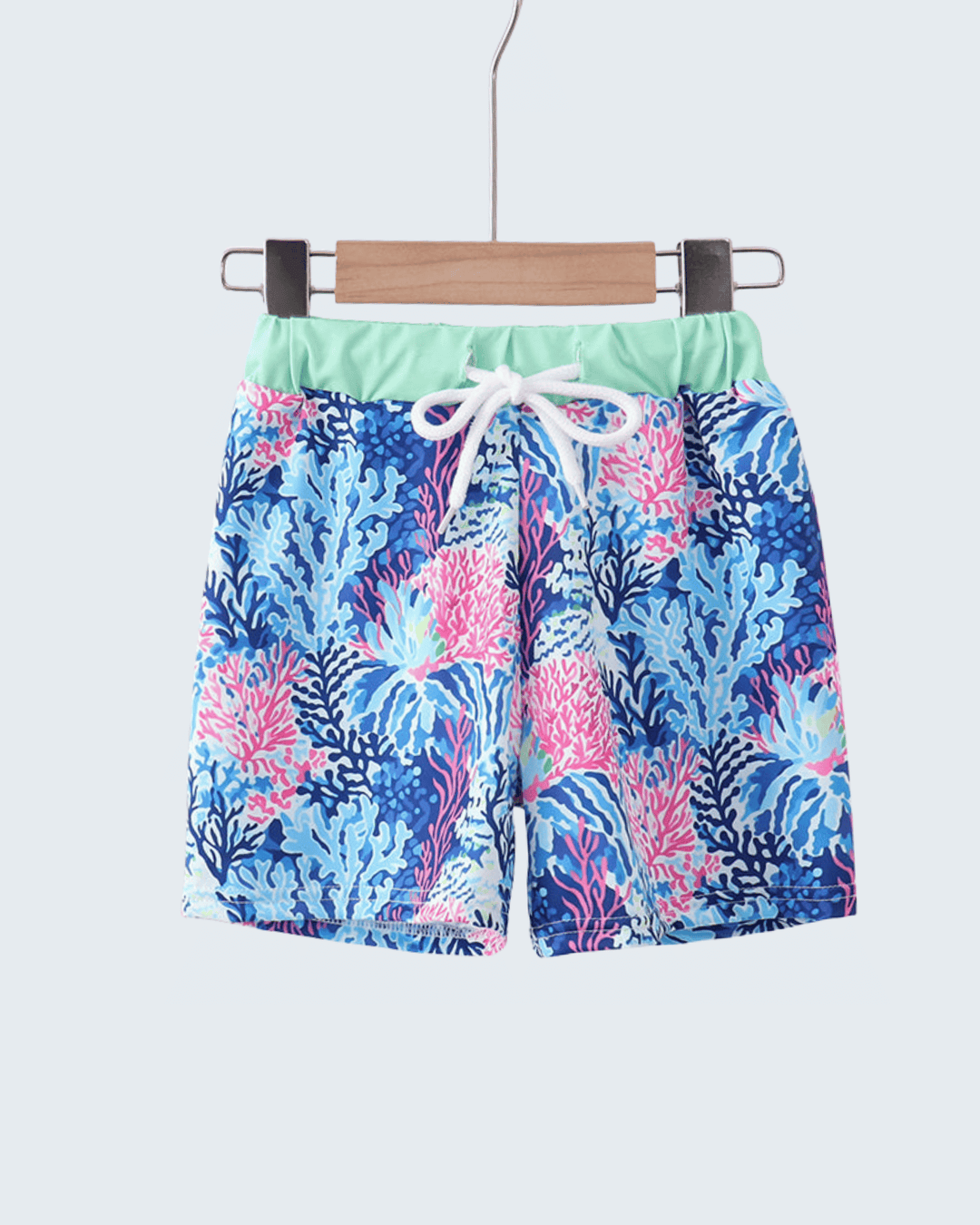 Colorful floral-patterned shorts on a hanger against a white background