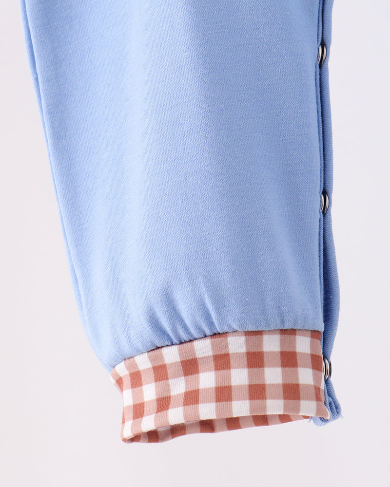 Light blue baby romper leg with orange-and-white plaid cuff and side snaps