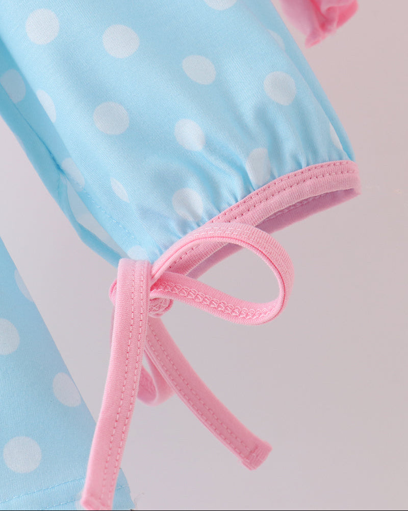 Blue dotted sleeve with pink tie bow and pink ruffled cuff