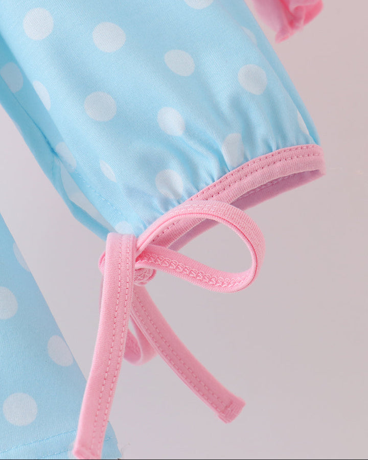 Blue dotted sleeve with pink tie bow and pink ruffled cuff