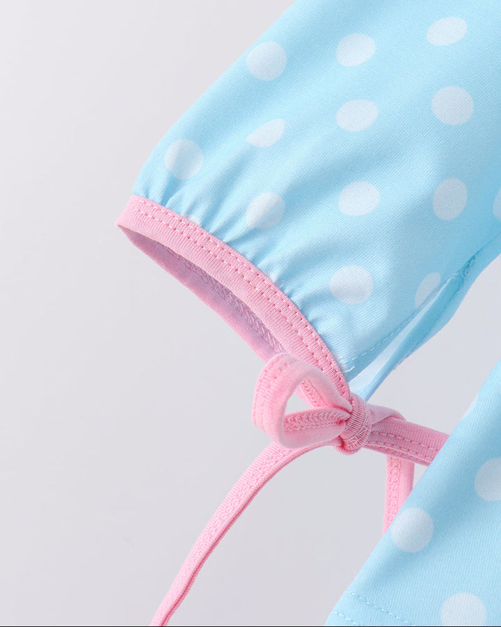 Blue dotted dress with pink tie waist and pink trim cuff