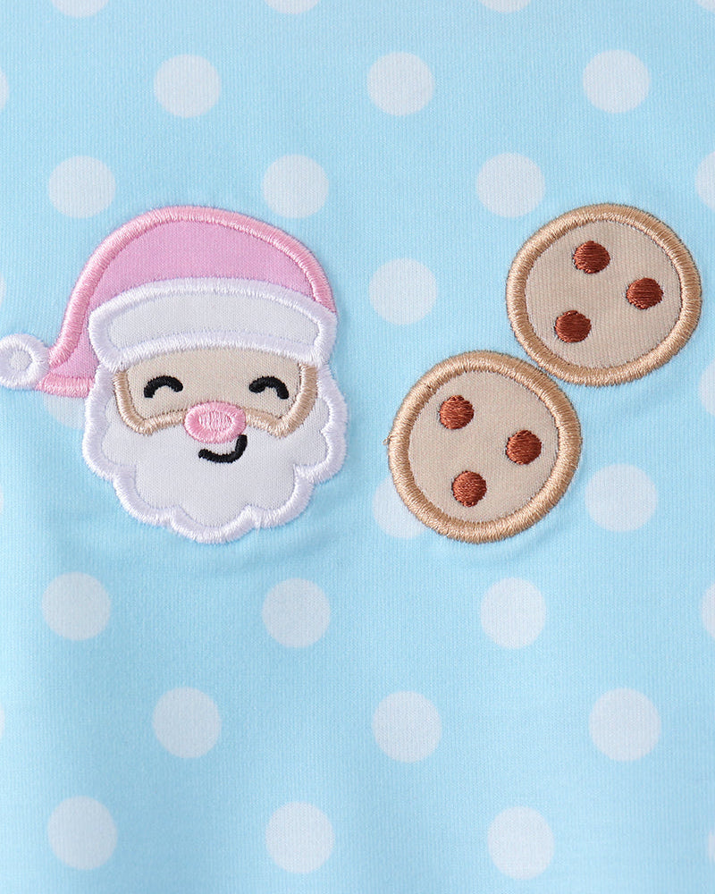 Light blue top with pink-trimmed appliques of Santa face and cookie icons