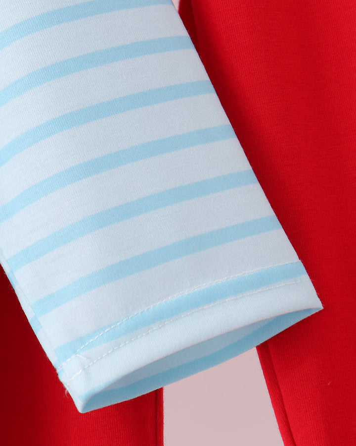 Light blue striped long-sleeve pajama cuff over red pants
