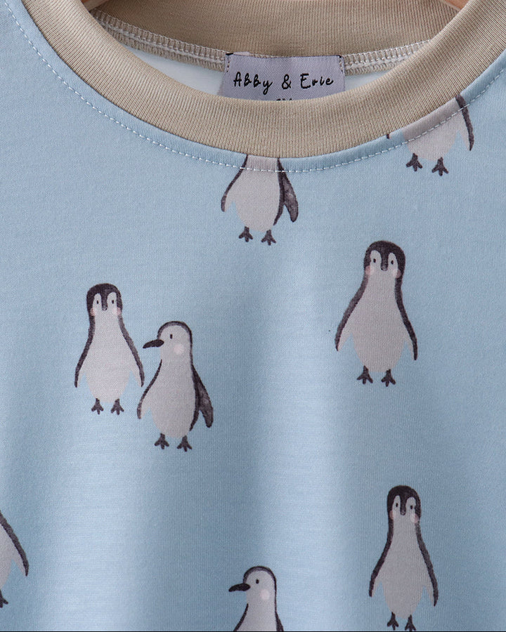 Light blue shirt with penguin pattern on a hanger, brand &