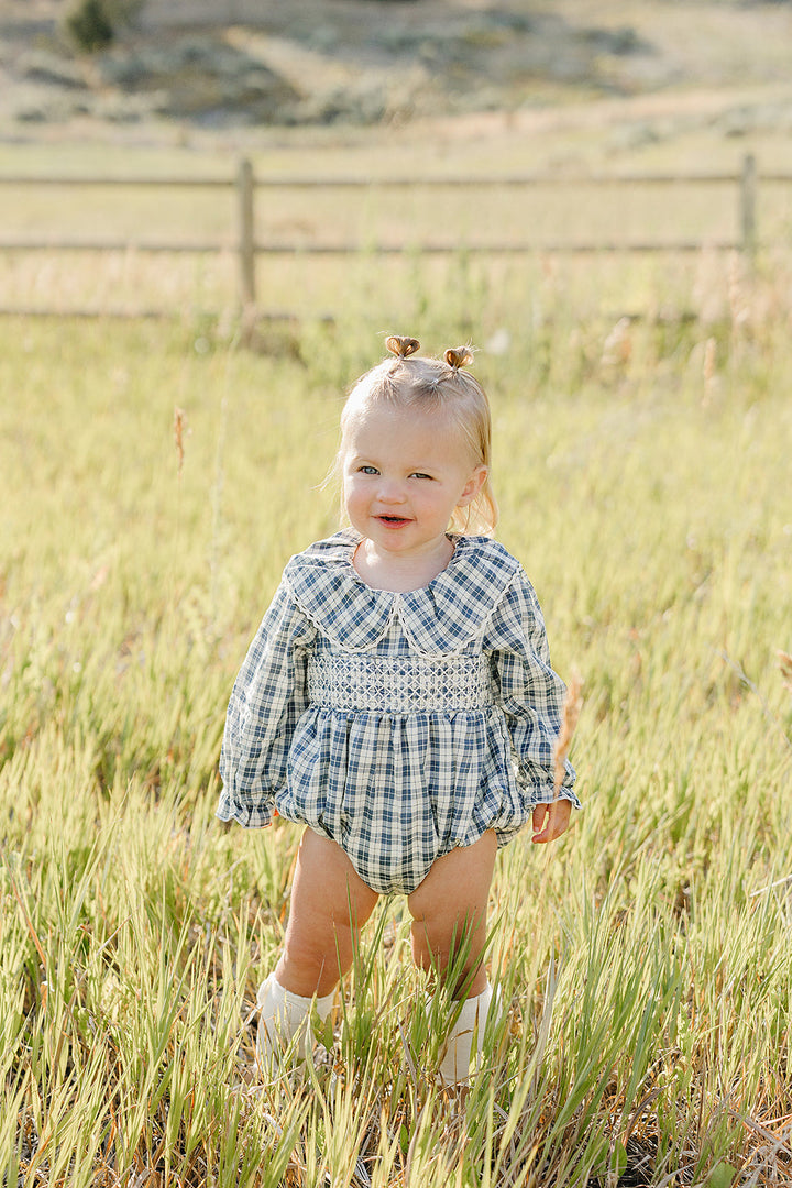Blue plaid ruffle-collar bubble romper on baby, long sleeves and gathered waist