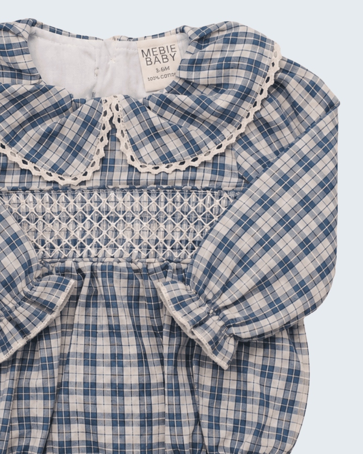 Blue plaid romper with ruffle collar, smocked bodice, and bow-tie sleeves