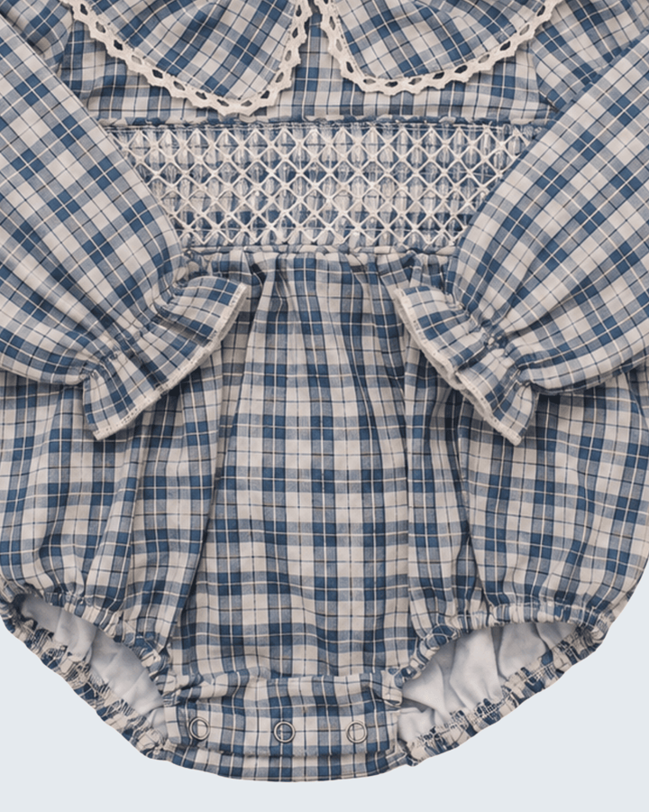 Blue plaid bubble romper with smocked yoke, gathered waist, and snap buttons